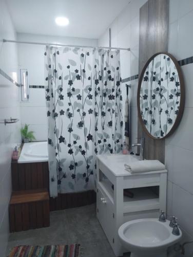 a bathroom with a sink and a shower curtain at Buenos Aires de Ezeiza Duplex- Piscinas- Playroom- Sauna in La Unión