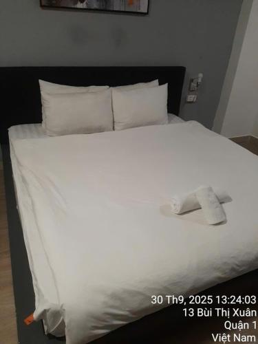 a white bed with white sheets and pillows at Khap Khap Thai Res Hotel 4 in Ho Chi Minh City