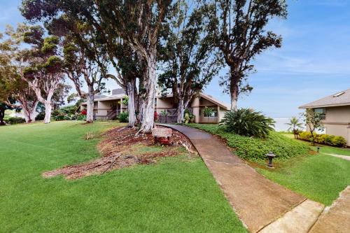 a house with a tree in the yard at Pali Ke Kua 111 in Princeville