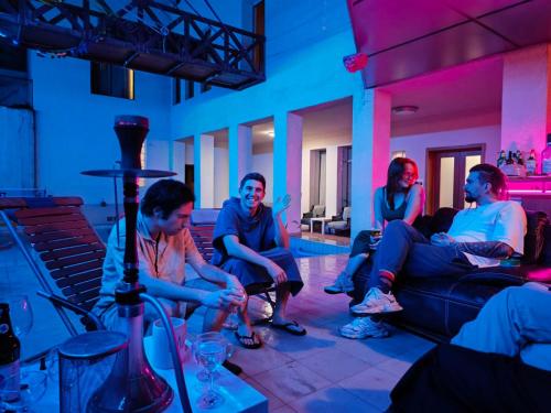 a group of people sitting on a couch in a room at Colibring nomads in Tbilisi City