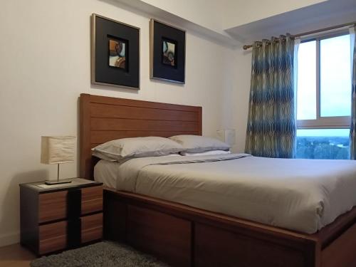 a bedroom with a large bed and a window at Marquee Residences in Angeles