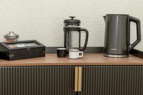 a coffee maker on a wooden counter top with a coffee pot and a coffeeicter at Stay in Chianti in Greve in Chianti