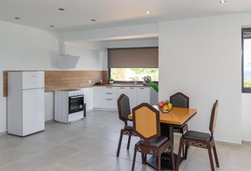 a kitchen and dining room with a table and chairs at arvangroup-apartments in Nafpaktos