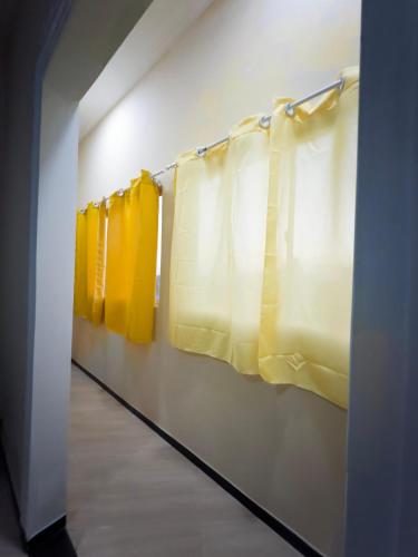 a row of yellow curtains in a hallway at Garrida in Itarema