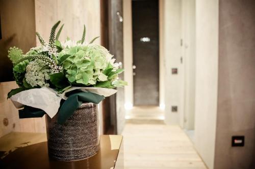 a vase filled with flowers sitting on a table at Benci House in Florence