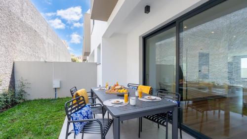 a dining table on the patio of a house at Villa Nero by LovelyStay in Funchal