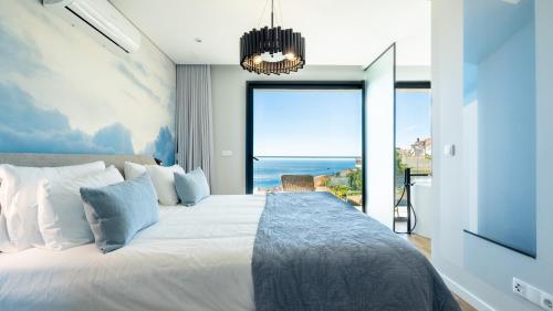 a bedroom with a large bed with a view of the ocean at Villa Nero by LovelyStay in Funchal