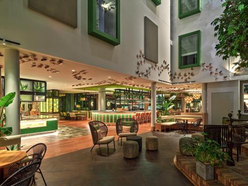 a restaurant with chairs and tables in a building at voco The Hague by IHG in The Hague