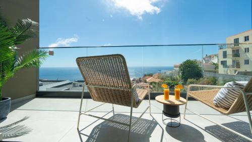 a balcony with a chair and a view of the ocean at Villa Nero by LovelyStay in Funchal