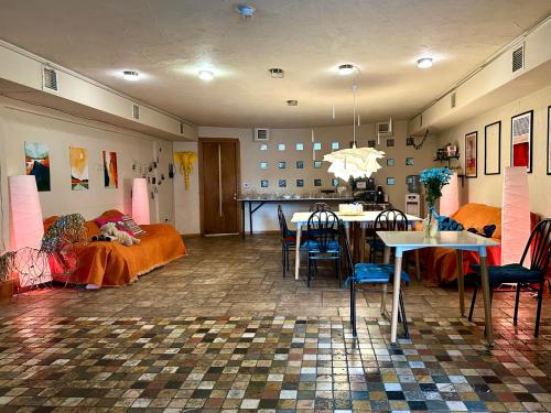 a living room with a table and a dining room at Colibring nomads in Tbilisi City