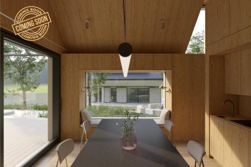 a kitchen and dining room with a table and chairs at Hygge Apartments in Rožmberk nad Vltavou