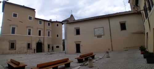 a group of benches in a courtyard next to a building at Al Borgo in Riano