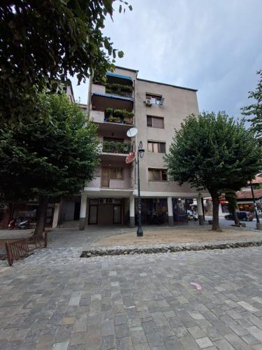 a building with a street light in front of it at Shadervan apartment in Prizren