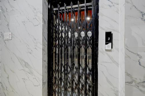 a black wine rack with wine bottles in it at HOTEL O DEVARA GRAND in Maula Ali