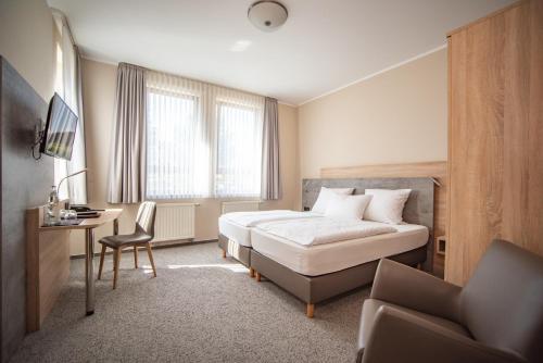 Postel nebo postele na pokoji v ubytování Hotel Hollmann