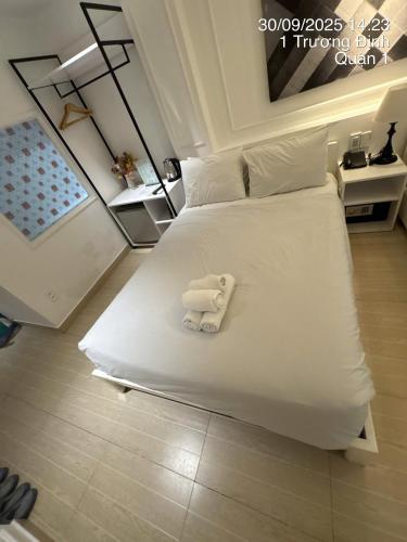 a white towel on a bed in a room at Balack Hutsa Hotesl 7 in Ho Chi Minh City