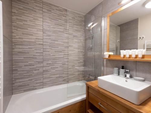 a bathroom with a tub and a sink and a shower at Confortable Appartement Familial aux Saisies avec Balcon et Parking - FR-1-809-6 in Les Saisies
