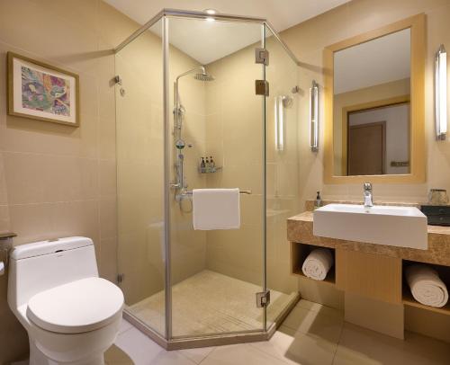 a bathroom with a shower and a toilet and a sink at True Go Hotel - Guangzhou International Conference Center Memorial Hall Subway Station in Guangzhou