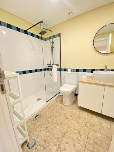 a bathroom with a shower and a toilet and a sink at Exclusive Apartment in Quarteira Walk to Beach in Quarteira
