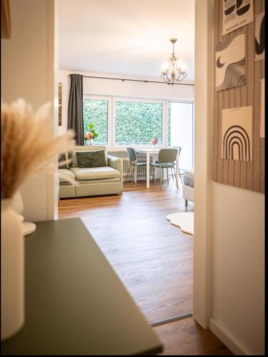 a living room with a couch and a table at Black Forrest Base Vauban in Freiburg im Breisgau