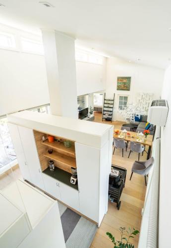 an open kitchen and dining room with white cabinets at Exclusive Villa Wikkelä Ranua with Sauna & Jacuzzi in Ranua
