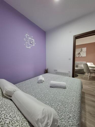 a bedroom with a large bed with purple walls at Apartman Dora in Jagodina