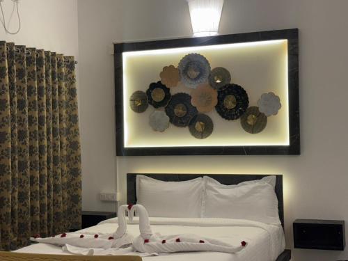 a bedroom with a bed with a picture on the wall at Le Park Luxury Resort - TIE Hotels & Resorts in Puducherry