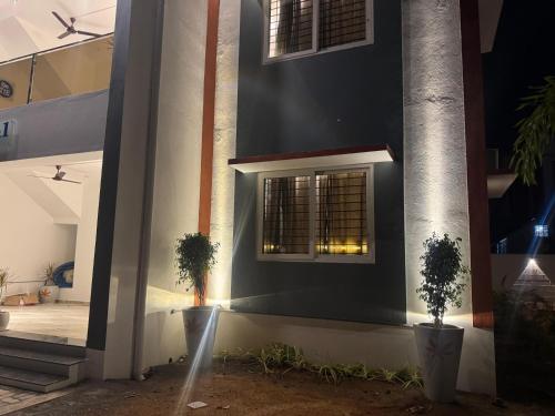 a building with two potted plants on the side of it at Le Park Luxury Resort - TIE Hotels & Resorts in Puducherry