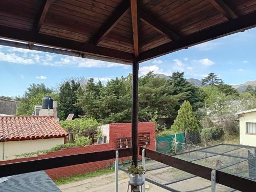 a view of a tennis court from the balcony of a house at Hostería Las Gemelas in Capilla del Monte