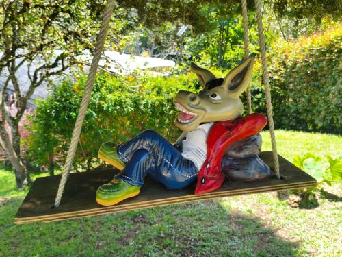 a statue of a rabbit sitting on a swing at Glamping Cabañas Sharmont in Guarne