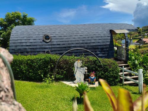 a statue in the yard of a house at Glamping Cabañas Sharmont in Guarne