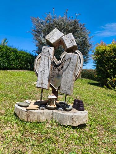 a statue sitting on top of a grass field at Glamping Cabañas Sharmont in Guarne