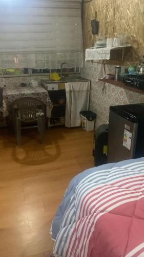 a bedroom with a bed and a table and a desk at Mecohue in Chaitén