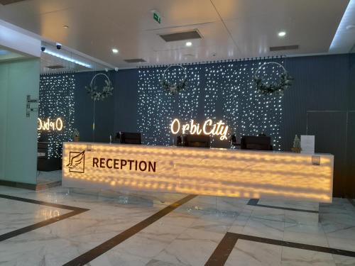 a wooden bench in a lobby with a reception at Orbi siti in Batumi