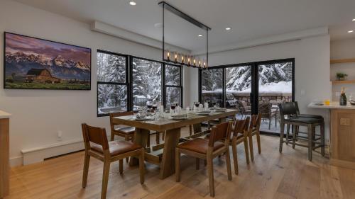 a dining room with a long table and chairs at Chalet Bello in Beaver Creek