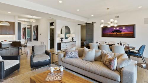 a living room with a couch and a dining room at Chalet Breton in Steamboat Springs