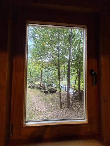 a window with a view of a woods at Jeskyně Jánská in Janská