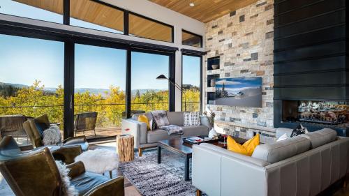a living room with couches and a fireplace at Chalet Cascada in Steamboat Springs