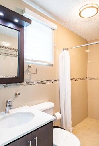 a bathroom with a sink and a shower at Aquaville Dorado Moderna Villa 1 in Dorado