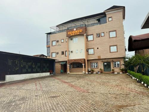 a large building with a sign that reads escape at Iconic Hotel and Lounge in Alagbado