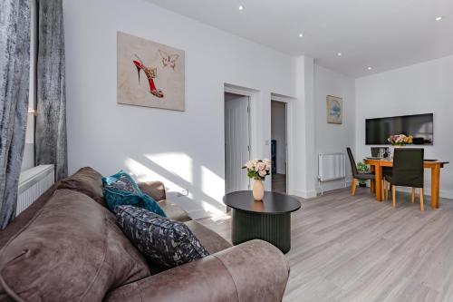 a living room with a couch and a table at Blue Horizon Seaside Apart in Clacton-on-Sea
