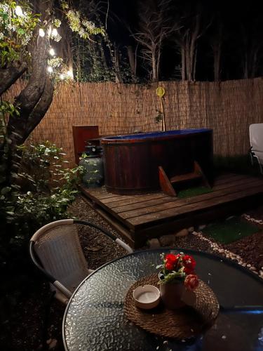 a table with a bowl of flowers on top at El Encanto del Manzano & Espacio Vittalia Spa in San José de Maipo