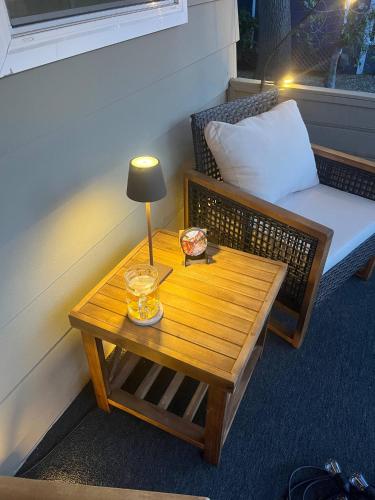 a table with a lamp and a bench in a room at Walk to Downtown | Workspace + Pet Friendly in Pleasanton