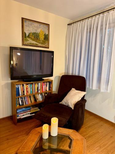 a living room with a couch and a flat screen tv at Głuszyńska Przystań in Stawiska