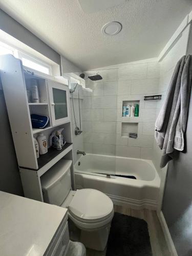 a bathroom with a toilet and a bath tub at Walk to Downtown | Workspace + Pet Friendly in Pleasanton