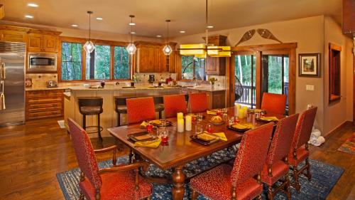 a kitchen with a wooden table and chairs in a kitchen at Chalet Fuego in Steamboat Springs