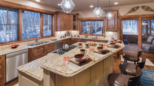 a kitchen with wooden cabinets and a large island at Chalet Fuego in Steamboat Springs