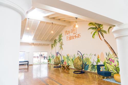a room with a palm tree mural on the wall at Hotel Playa Palmeras Cartagena - Vía al Mar in Cartagena de Indias
