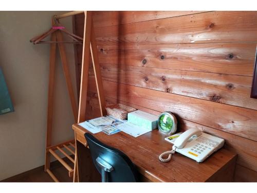 a desk with a phone and a clock on it at Hotel Park Light - Vacation STAY 39472v in Inai