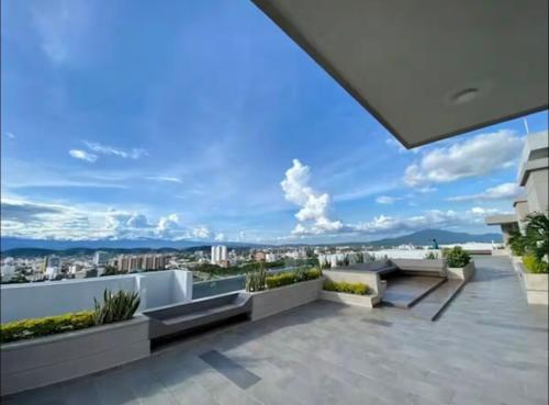 a balcony with benches and a view of a city at Central Suite in Cúcuta